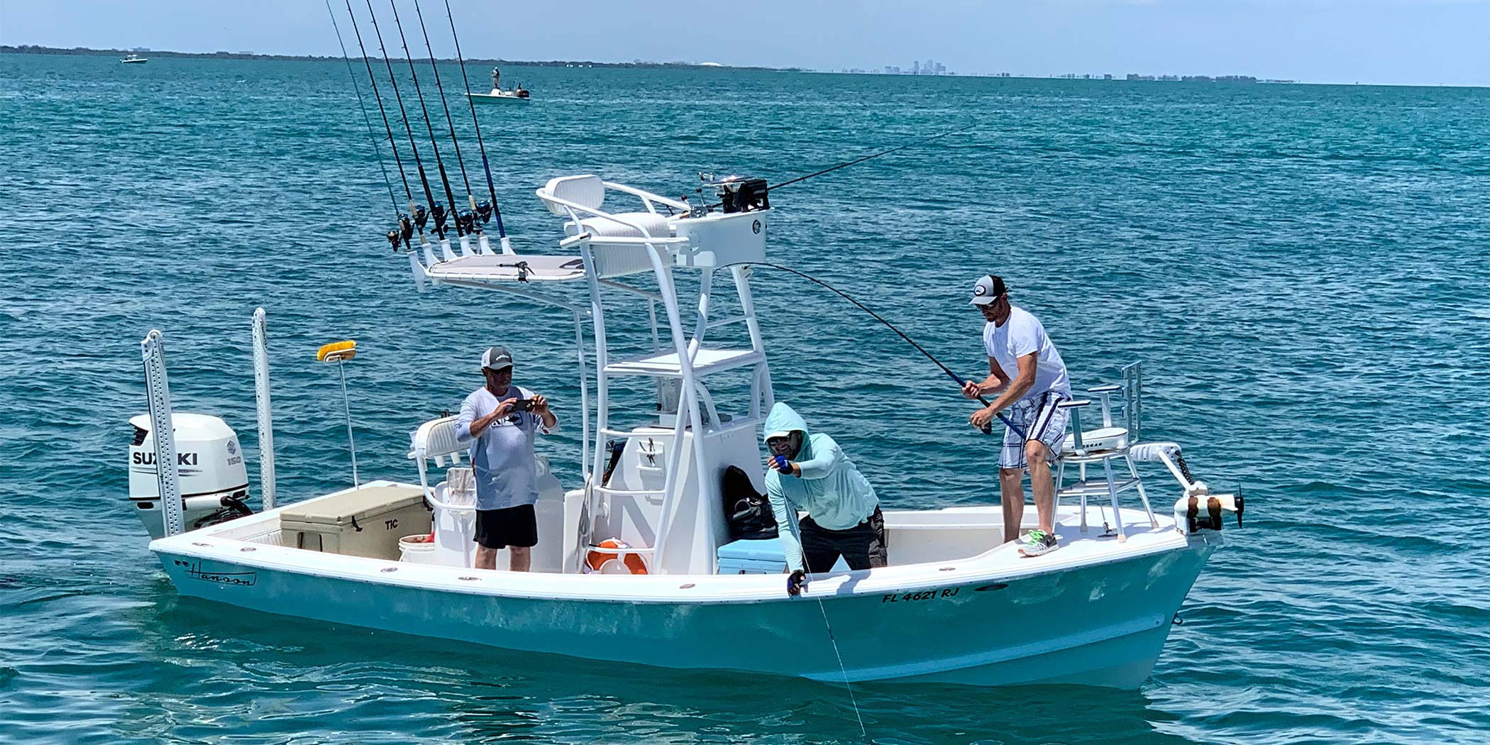 InshoreAction Charter - Drone View Client hooked up on a fish during a charter, as scene from a drone's perspective.