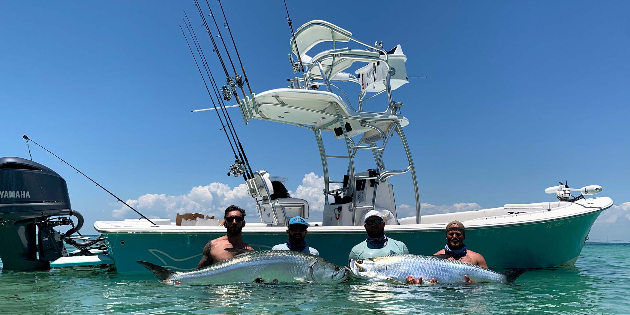 Pair of Tarpons - InshoreAction Charters Landed a pair of big tarpons during a summer charter, and had to pose with them next to the boat.